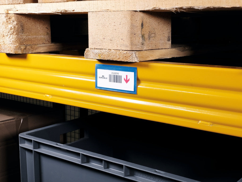 Durable small magnetic label pouch with a barcode on a yellow racking beam above grey crates