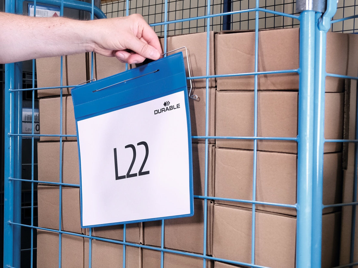 Hand hanging a Durable A4 landscape wire hanger pocket with an L22 label on a roll cage