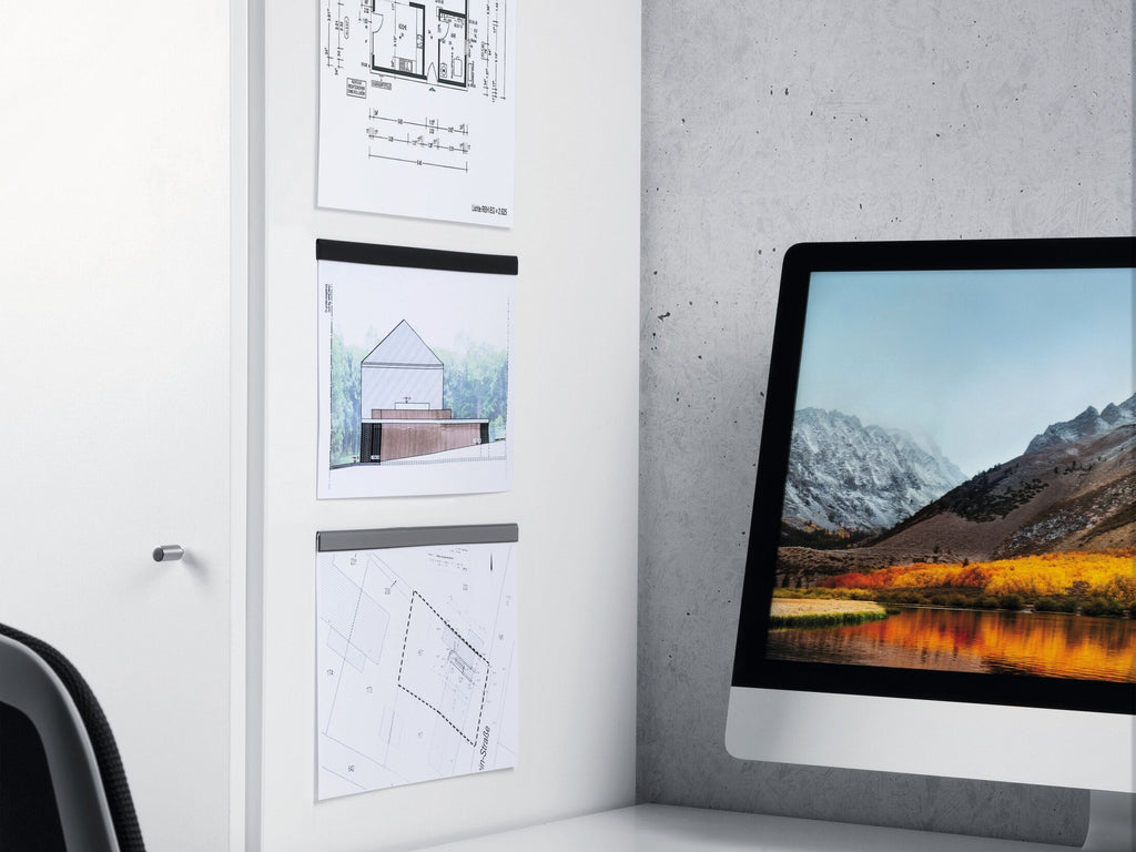 Durable Durafix rails holding a floor plan, a house photo and a sketch on a white cabinet beside a monitor
