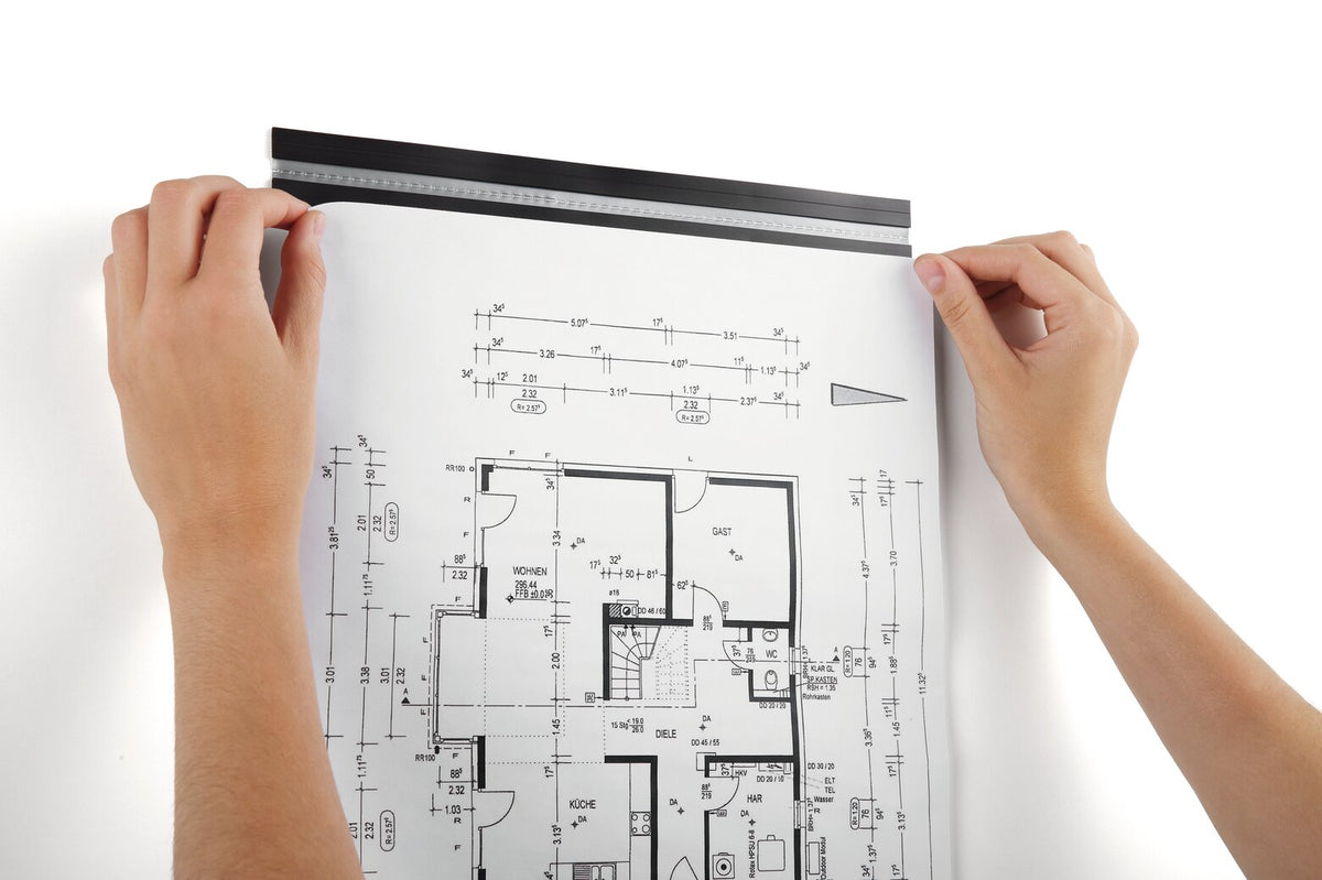Hands sliding a floor plan under a Durable Durafix rail fixed to a white wall