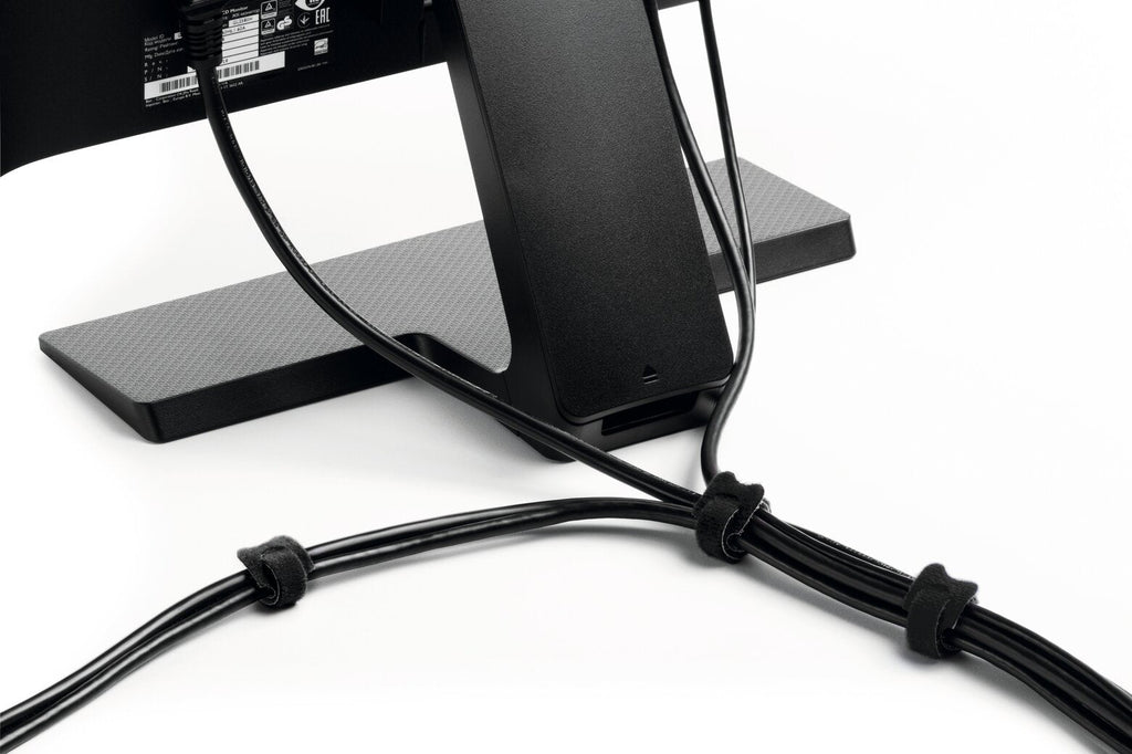 Black CAVOLINE GRIP TIE ties bundling cables behind a monitor stand