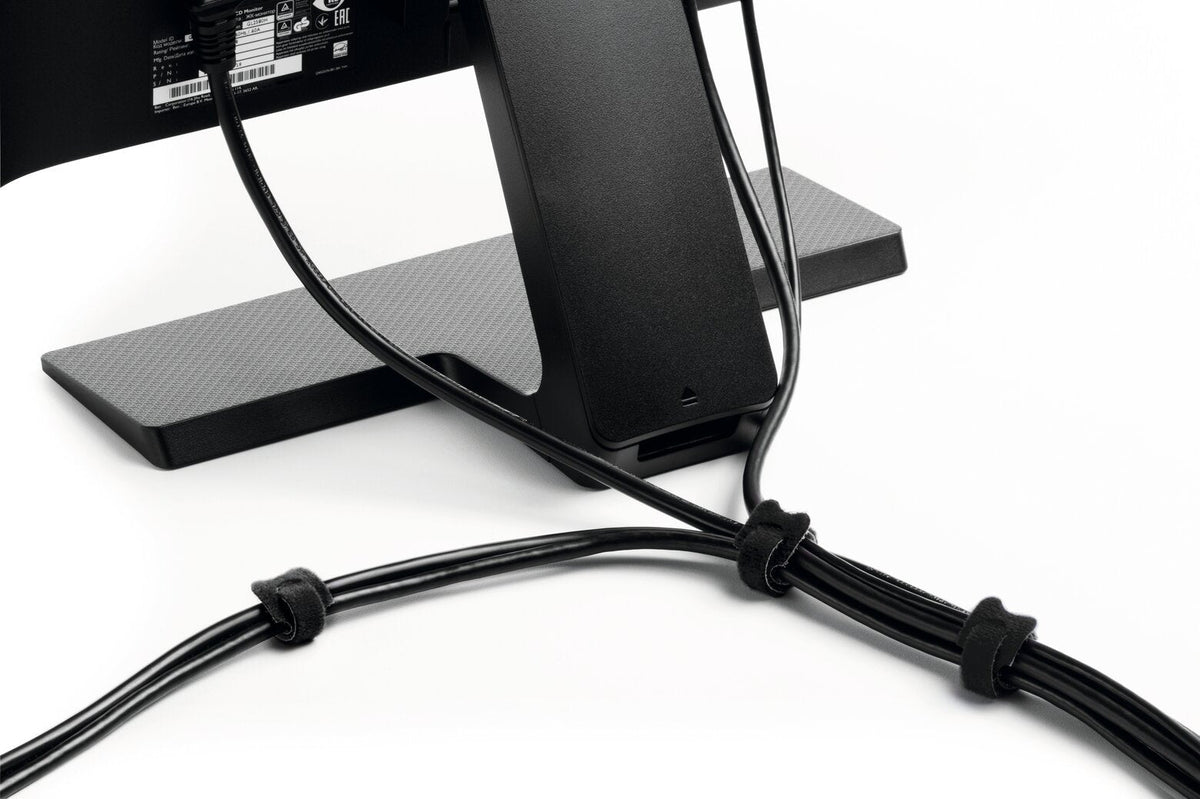 Black CAVOLINE GRIP TIE ties bundling cables behind a monitor stand