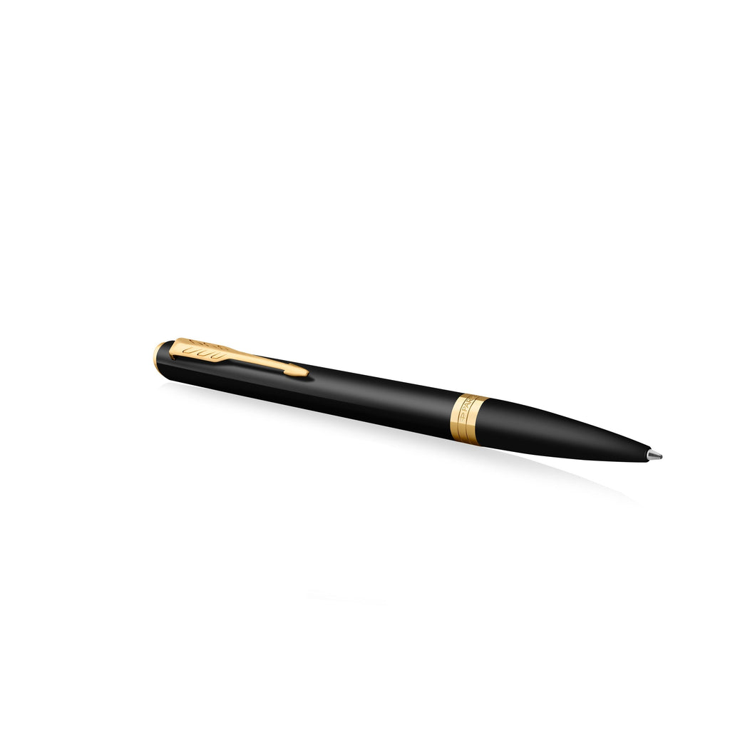 Matte black Meridian ballpoint lying at an angle with the arrow clip on top and the gold PVD centre band visible