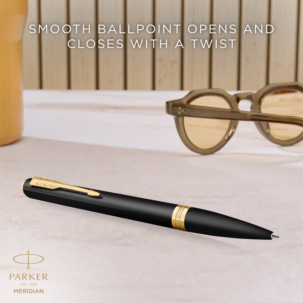 Matte black Meridian ballpoint resting on a desk, with Parker's caption that the smooth ballpoint opens and closes with a twist