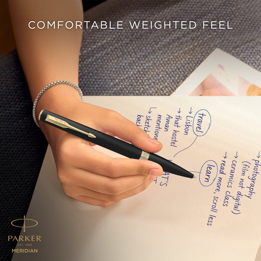 Hand writing with the matte black Meridian ballpoint, captioned comfortable weighted feel
