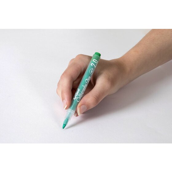 Hand writing with a pastel green Artline Calligraphy Pen 2.0