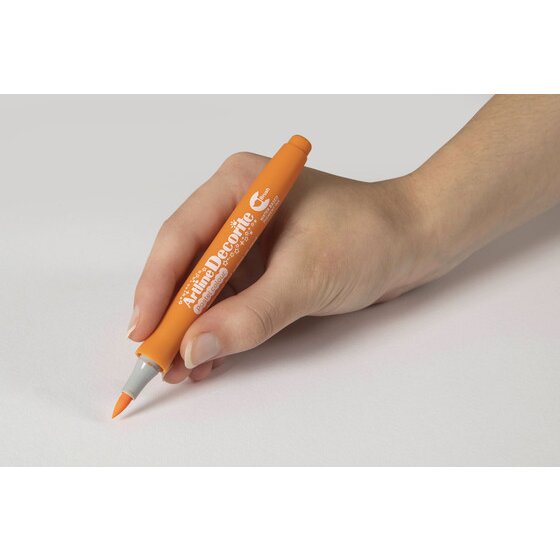 Hand writing with an Artline Decorite Brush Pastel Orange marker