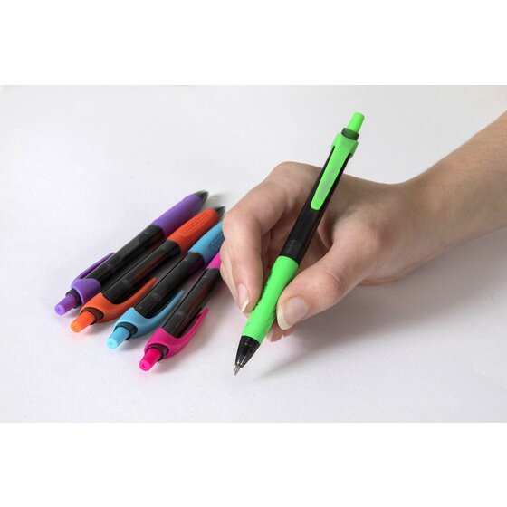 Hand writing with an Artline Ikonic pen from the brights pack, the other pens laid beside it